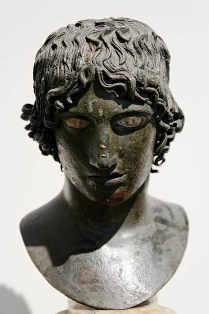 Villa dei Papiri, Herculaneum. Bronze bust of a Mellephebe (Eros as a young boy). Found in 1752, in the centre of room.
Now in Naples Archaeological Museum. Inventory number 5633.